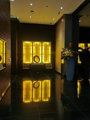 a lobby with a vase of flowers and windows at Cruz Air Residences in Manila