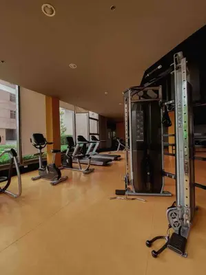 a gym with a bunch of exercise equipment in a room at The Radiance Manila Bay - Modern 1-Bedroom Condo with View in Manila