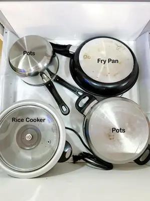 a group of pots and pans sitting on a counter at Acqua Private Residence Livingstone Tower Condo Unit with Free Wifi in Manila