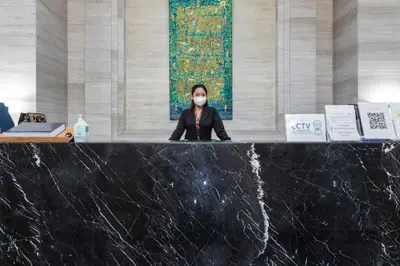 a woman wearing a mask at a counter in a building at The Radiance Manila Bay in Manila
