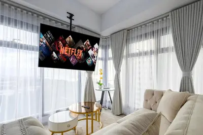 a living room with a couch and a tv on the wall at The Radiance Manila Bay in Manila