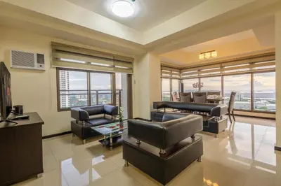 a large living room with couches and chairs at The Radiance Manila Bay in Manila
