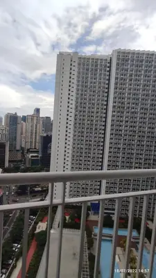 a large white building with a city in the background at Jazz Residences (Destina Stays)Makati, Metro Manila in Manila