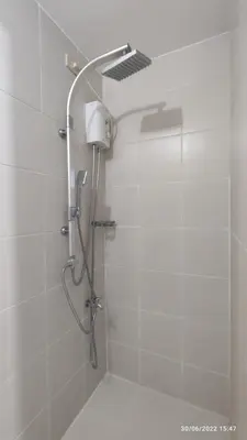 a shower with a shower head in a bathroom at Netflix, Destina Stays at Jazz Residences Makati, MetroManila in Manila