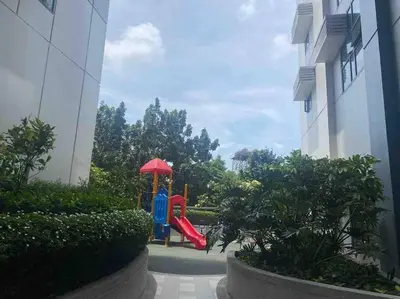 a playground in a building with a red slide at Studio at viceroy t4 Florence way in Manila