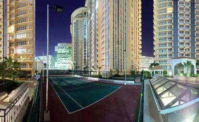 a tennis court in a city with tall buildings at Studio at viceroy t4 Florence way in Manila