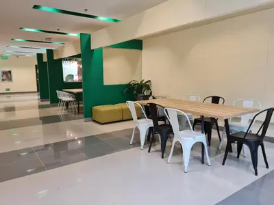 a conference room with a wooden table and chairs at Go Hotels Otis - Manila in Manila