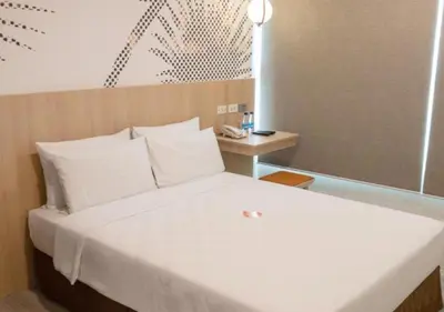 a bedroom with a large white bed in a room at Go Hotels Plus Mandaluyong in Manila