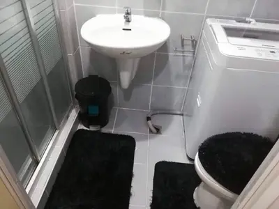a small bathroom with a sink and a toilet at Alatonplace sea residences in Manila
