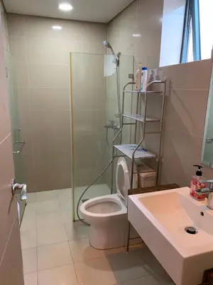a bathroom with a shower and a toilet and a sink at MRMCONDOTEL cluster 1 2H in Manila