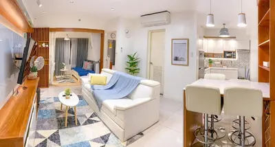 a living room with a white couch and a table at Large 1-Bedroom Condo 60sqm Makati Rockwell CBD Poblacion in Manila
