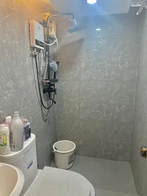 a bathroom with a toilet and a shower in it at IV’s Condo w/ Netflix, Wifi & Karaoke in Cainta