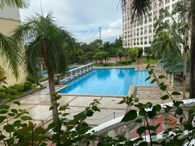 a swimming pool in the middle of a building at IV’s Condo w/ Netflix, Wifi & Karaoke in Cainta
