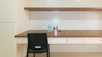 a black chair sitting next to a kitchen counter at RedDoorz Plus near Nakpil St Taft Avenue in Manila