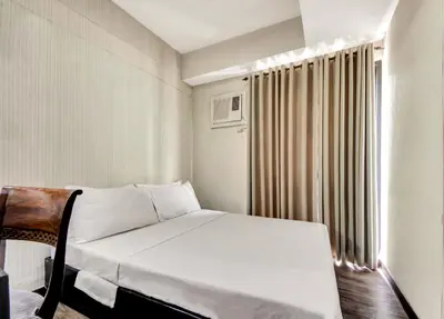 a small room with a bed and a window at CEO Flats in Manila