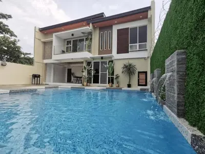 a swimming pool in front of a house at Newly Built Private Villa with Pool in Cainta in Cainta