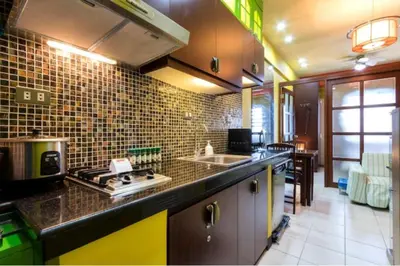 a kitchen with a sink and a stove top oven at BalaiB1 Cozy Studio in Ortigas Center in front of Galleria in Manila