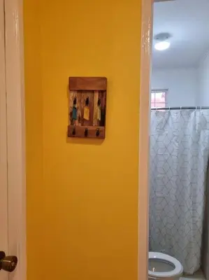 a bathroom with a yellow wall and a toilet at #30 Bel Air House by Red Door House Rental in Santa Rosa