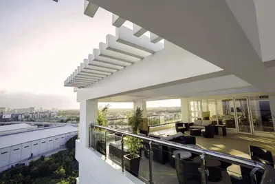 a building with a balcony with a view of a living room at affordable staycation alabang in Manila