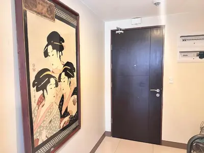 a large painting on the wall next to a door at Premium Executive Suite at Venice Luxury Residences in Manila