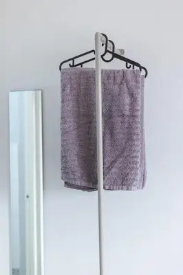 a gray curtain hanging on a rod in a window at Hive Manila Guesthouse -Netflix,400mbps WI-FI in Bacoor