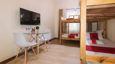 a small room with a table and a bunk bed at RedDoorz Plus @ Cuarto Verde Staycation in Manila