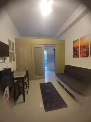 a living room with a couch and a table at Sweet Stays 888 in Manila