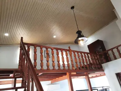 a wooden staircase in a house with a ceiling at Omotenashi House of Santa Rosa City Laguna in Caingin