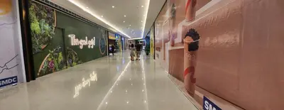 a hallway in a building with people walking down it at SMDC AIR RESIDENCES in Manila