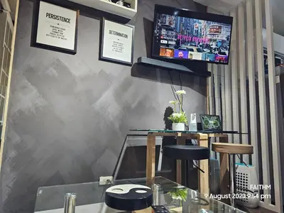 a bar with two stools and a tv on a wall at SMDC AIR RESIDENCES in Manila