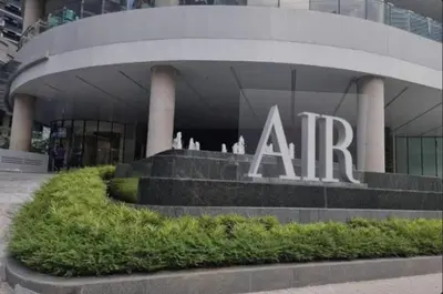 a large building with a sign in front of it at SMDC AIR RESIDENCES in Manila