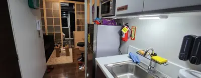 a kitchen with a sink and a refrigerator at SMDC AIR RESIDENCES in Manila
