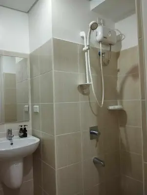 a bathroom with a shower and a sink at SnugglePod Condotel - Grand Riviera Suites, US Embassy Manila, Roxas Blvd in Manila