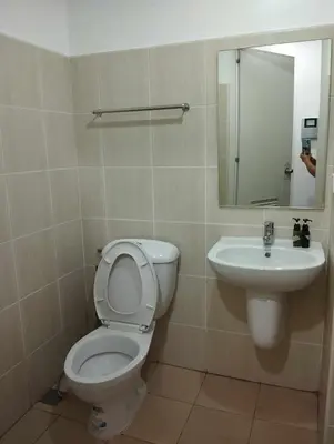 a bathroom with a toilet and a sink at SnugglePod Condotel - Grand Riviera Suites, US Embassy Manila, Roxas Blvd in Manila