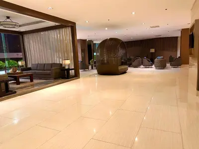 a lobby of a hotel with a couch and chairs at Luxury Seaside Sunset View at SM Mall of Asia with free parking in Manila