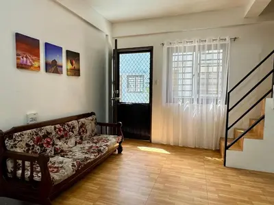 a living room with a couch and a window at Sebastians Crib in Dasmariñas