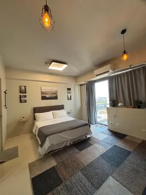 a bedroom with a bed and a large window at One Palm Tree Villas short walk via Runway Manila NAIA T3 in Manila