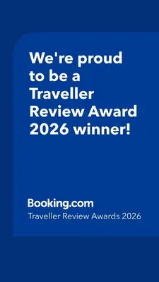 a blue sign that says were proud to be a traveller reviewagency winner at One Palm Tree Villas short walk via Runway Manila NAIA T3 in Manila