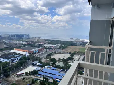 a view of a city from a building at City and Sea view Staycation at Coast Residences in Manila