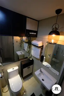 a bathroom with a white toilet and a sink at DM's Place Family Suite B - Condo in Pasay in Manila
