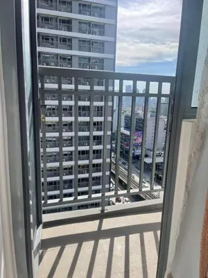 a balcony with a view of a large building at Staycation Mandaluyong Fame residences greenfield district by darpm in Manila