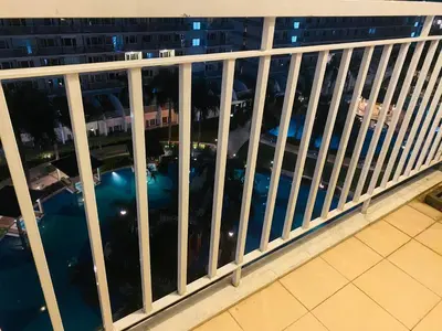 a balcony with a view of the city at night at SHELL RESIDENCE c12 NEAR AIRPORT SHORWALK TO MALL OF ASIA in Manila