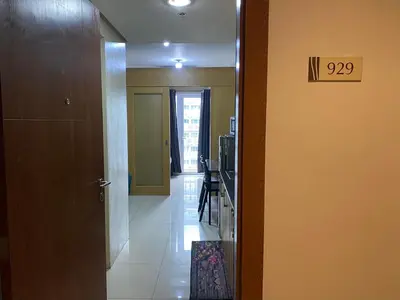 a hallway with a door to a room with a kitchen at SHELL RESIDENCE c12 NEAR AIRPORT SHORWALK TO MALL OF ASIA in Manila