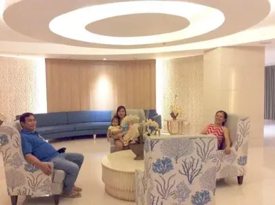 a group of people sitting in a waiting room at SHORE RESIDENCE D8 NEAR aiRPORT & SHORTWALK TO MALL OF ASIA in Manila