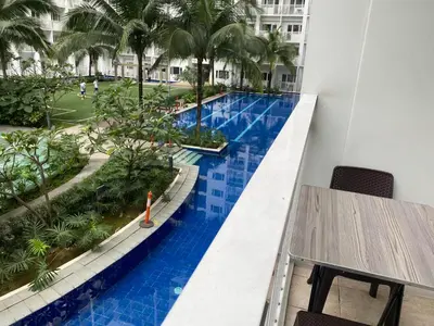 a view of a pool from the balcony of a hotel at SHORE RESIDENCE D8 NEAR aiRPORT & SHORTWALK TO MALL OF ASIA in Manila