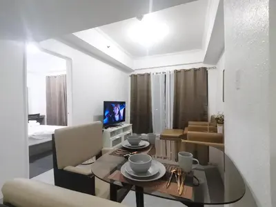 a living room with a table and a dining room at Accommodation services in Manila