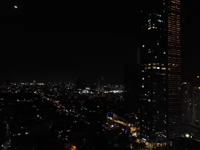 a city skyline at night with tall buildings at Accommodation services in Manila