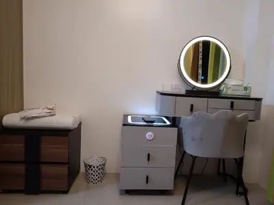 a dressing room with a mirror and a chair at Shore Residence Tower C2 in Manila