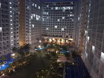 a view of a city at night with buildings at SHORE RESIDENCE D9 Shortwalk Mall of Asia Near Airport in Manila