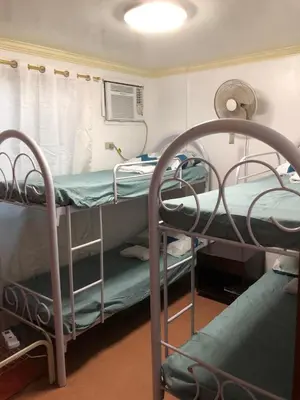a room with two bunk beds in a hospital at THE MANSION: FAMILY AND BARKADA BONDING PLACE IN PASAY NEAR AIRPORT in Manila